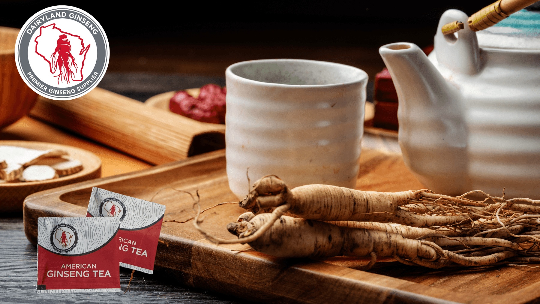 Wisconsin ginseng tea bags with whole American ginseng roots, ceramic cup, and teapot on wooden tray