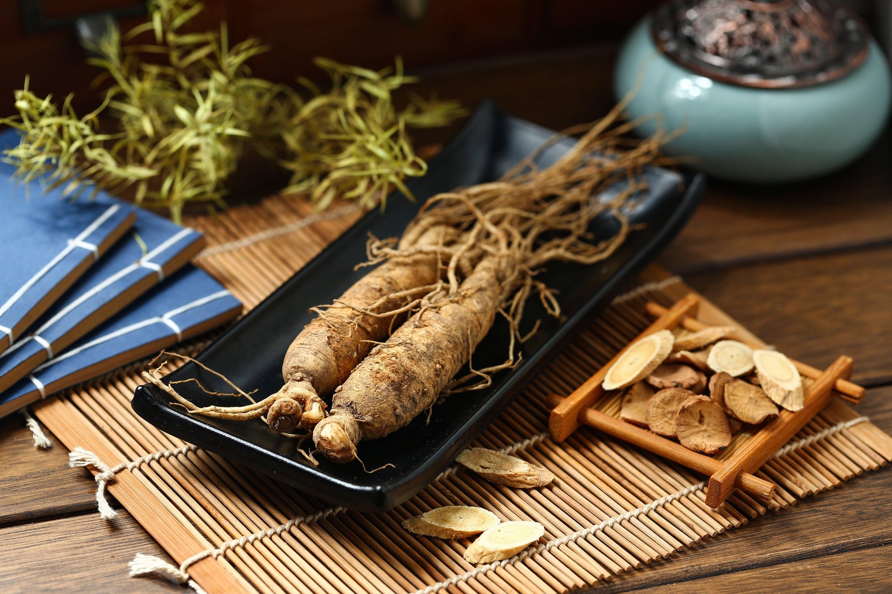 Wisconsin ginseng roots and dried slices on bamboo mat, natural non-GMO farm-grown quality